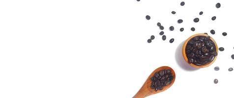 Roasted coffee bean on small wooden bowl and spoon isolated on white background with copy space photo
