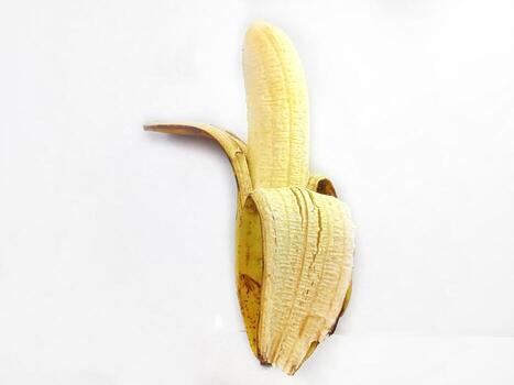 Banana isolated. Ripe peeled banana on a white background with copy space photo