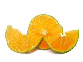 half lemon and slice isolated on white background. orange peel is green. photo