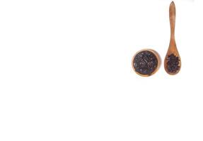 Roasted coffee bean on small wooden bowl and spoon isolated on white background with copy space photo