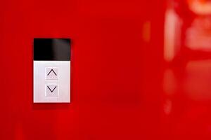 Elevator button on red wall. Elevator Button up and down direction with copy space. photo