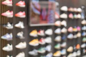 Abstract Blur Background of Row of shoes on display in shop. A view of a wall of shoes inside the store. Modern new stylish sneakers running shoes. photo