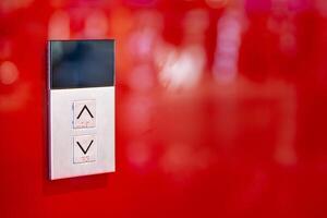Elevator button on red wall. Elevator Button up and down direction with copy space. photo