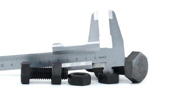 Caliper measuring a metal nut, illustrating precision engineering and industrial tools on a white photo