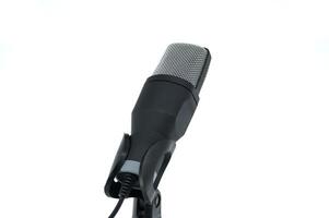 Close-up of a professional microphone on a stand, isolated on a white background photo