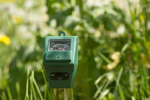 Measure soil with three way digital device photo