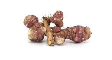 Fresh raw Jerusalem artichokes isolated against a white background photo