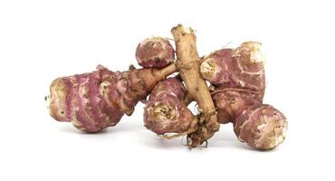 Fresh raw Jerusalem artichokes isolated against a white background photo