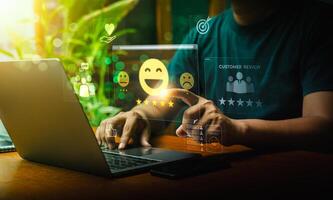 User Typing on Laptop to Submit Customer Feedback with Digital Satisfaction Ratings, Featuring Virtual Icons for Positive Review, Customer Service, and Online Consumer Interaction in Business Platform photo