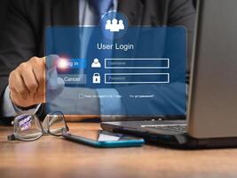 Businessman in a suit touching login button to the network system on a virtual screen photo