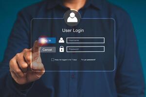 Businessman touching login button to the network system on a virtual screen photo