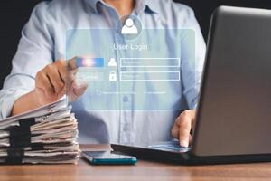 Businessman touching login button to the network system on a virtual screen photo