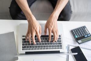 Business man working using laptop computer Hands typing keyboard. Professional investor working start up project. business planning in office. Technology business Concept photo