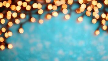 Abstract blurred Christmas lights on a turquoise blue background with copy space. photo