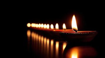 Row of lit candles in the dark, creating a peaceful and spiritual atmosphere. photo