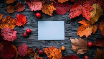 Autumn background with colorful leaves and blank card on rustic wood. Fall, Thanksgiving, or Halloween concept. photo