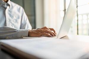 Business man working using laptop computer Hands typing keyboard. Professional investor working start up project. business planning in office. Technology business photo