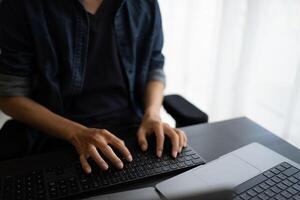 Asian man software engineer Working on Computer at office desk for writing program code IT Software Engineer finding errors tech support devops creating digital photo