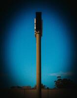 Minimalist Vertical Column Structure Against A Deep Blue Sky At Sunset photo