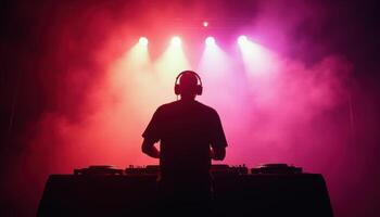 DJ Performing on Stage with Colorful Lights and Fog photo