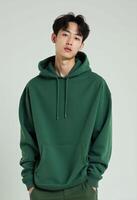 Young Korean Man in Green Hoodie Posing with a Calm Expression photo