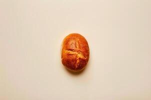 Minimalistic loaf of white bread with crust, top view photo