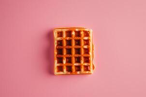 Rectangular Viennese waffle on pink background photo