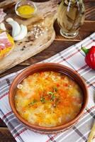 Minestrone soup. Vegetable soup with grilled bread, ham and spices photo