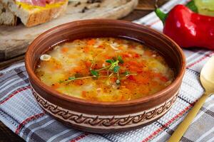 Minestrone soup. Vegetable soup with grilled bread, ham and spices photo