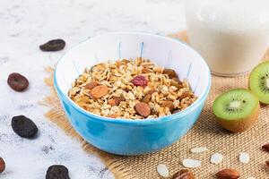 Bowl of granola with nuts, berries and yogurt. Muesli oats with fruits photo