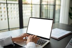 Business man using laptop blank screen computer working in office mockup image blank screen computer white background. photo