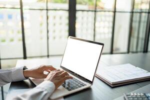 Business man using laptop blank screen computer working in office mockup image blank screen computer white background. photo