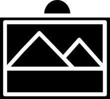 A black and white image of a camera with a mountain in the background vector