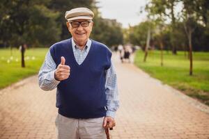 Portrait of happy senior man in park. He is relaxing and walking. photo