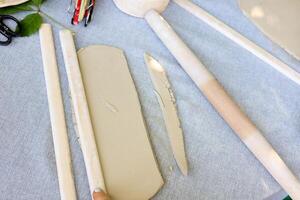 materials for sculpting from natural clay, a rolled strip of rope on the table photo