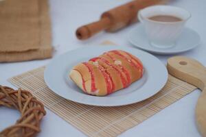 Strawberry bread with chocolate drink on white background photo