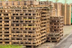 Stack of wooden pallets forming a wall in a storage area photo