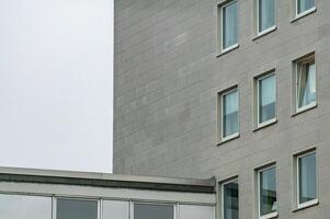 Modern building exterior with open window and grey facade photo