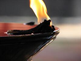 Closeup of lighted traditional Indian oil lamp photo