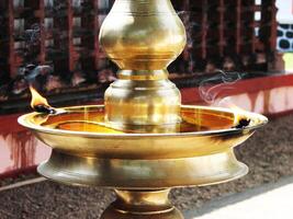 Closeup of lighted traditional Indian oil lamp photo