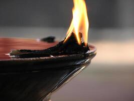Closeup of lighted traditional Indian oil lamp photo