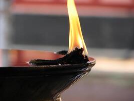 Closeup of lighted traditional Indian oil lamp photo