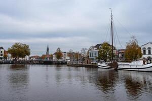 Delft, The Netherlands October 15, 2024. The harbour of Delft, with some old boats, and the skyline from the city. photo