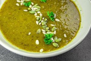 Spinach cream soup vegetable first course tasty food dish Fresh delicious gourmet food background on the table rustic food top view copy space top view keto and paleo diet Vegetarian and vegan food photo