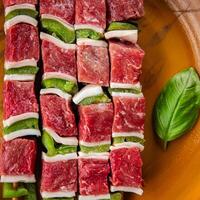 meat kebab raw vegetable, beef, lard, pepper dish fresh gourmet food background on the table rustic food top view copy space photo