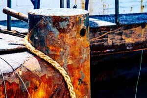 Rusty Industrial Dock with Weathered Metal and Rope in Vibrant Colors Capturing the Essence of Maritime Decay and Texture photo