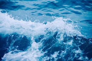 Dynamic Ocean Waves Crashing with Splashing Water and Vibrant Blue Tones Captured in Motion photo