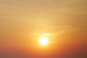 Stunning Golden Sunset with Vibrant Orange and Yellow Hues Creating a Serene and Tranquil Atmosphere in the Evening Sky photo