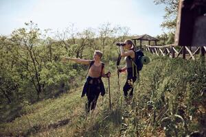 Mother And Daughter Using Binoculars While Hiking photo