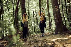 Mother And Daughter Enjoying Taking Deep Breath In The Forest photo